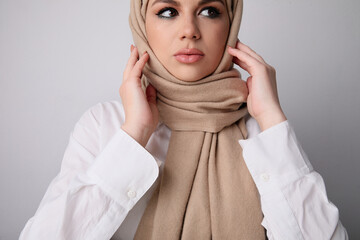 Young arab woman with serious face expression wearing islamic hijab. Isolated.