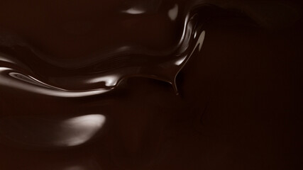 Closeup of splashing dark melted chocolate