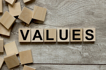 Values. wooden cubes on a wooden background. three wood blocks
