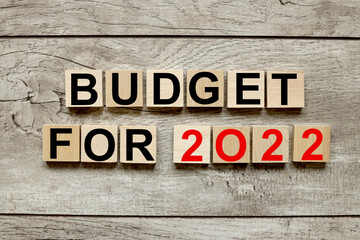 budget for 2022. wooden cubes on a wooden background. three wood blocks