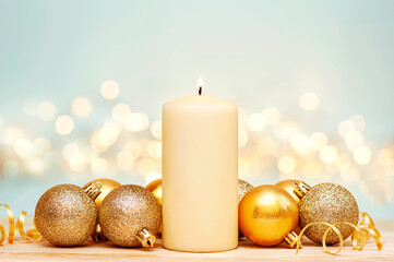 Christmas candle and gold ornaments on a blue background