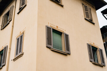Fototapeta na wymiar Facade of an old house with shutters on the windows in the town of Varenna