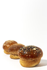 Assortment of small round brioche buns with homemade seeds