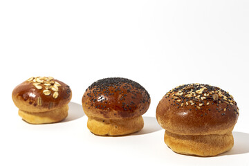 Assortment of small round brioche buns with homemade seeds