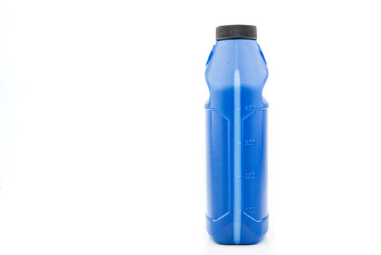 Blue measuring bottle with black lid. Brake fluid.
