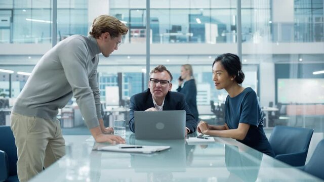 Multiethnic Diverse Office Conference Room Meeting: Team of Three Creative Entrepreneurs Talk, Discuss Growth Strategy. Stylish Young Businesspeople work on Digital e-Commerce Startup Project.