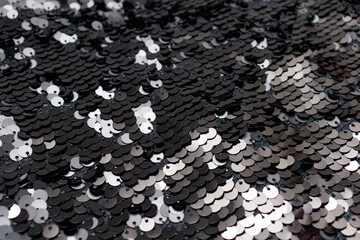 black sequins. Metallic Glitter background, sparkling sequined textile. Abstract Texture