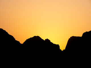 silhouette of a rocky mountain at sunset. Abstract picture with the shape of a mountain peak .