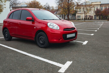 Fototapeta na wymiar Modern red car on parking lot outdoors