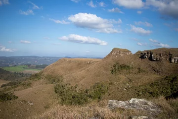top of the mountain in a day of blue sky, white clouds and green vegetation around © VictorHugo