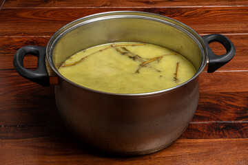 Making of marijuana green salve on wooden brown table