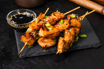 Grilled chicken fillet on skewers in teriyaki sauce. Asian style.