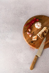 Wooden board with knife garlic and lard