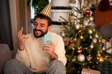 Young man uses a mobile phone during the New Year's celebration