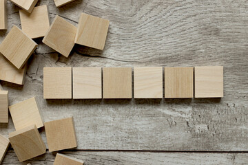 Empty six white cubes on a wooden background. a lot of wood blocks