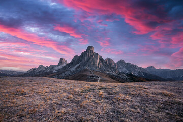 Picturesque landscape during incredible pink sunset in Italian Dolomites mountains. Passo Giau (Giau pass) with famous Ra Gusela and Nuvolau peaks on background. Dolomite Alps, Italy