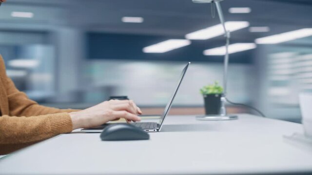 360 Degree Modern Office: Caucasian Businessman Sitting at His Desk Working on a Laptop Computer. Man working with Big Data e-Commerce Analysis. Energetic Fast Tracking Shot. Camera Moving Around