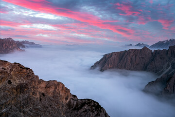 Dramatic sunrise landscape with flowing fog and pink skies in the Dolomites mountains. Location Auronzo rifugio in Tre Cime di Lavaredo National Park, Dolomites, Trentino Alto Adige, Italy