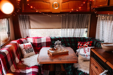 cozy kitchen interior in trailer of mobile home or recreational vehicle, concept of family local travel in native country on caravan or camper van and camping life in winter, Christmas and New Year