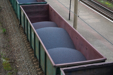 Freight train car with iron ore pellets