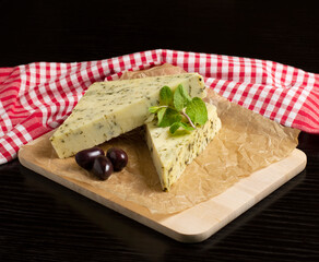 Herb Cheese triangles decorated with olives and mint