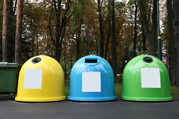 Waste sorting bins in park on autumn day