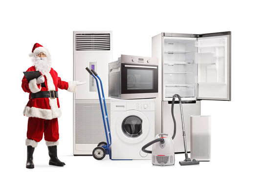 Full length portrait of santa claus holding a clipboard and pointing at electrical home appliances