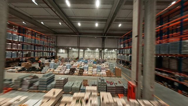 Logistic park. Aerial FPV flight inside modern huge retail warehouse storehouse building. Business industry. Product distribution.