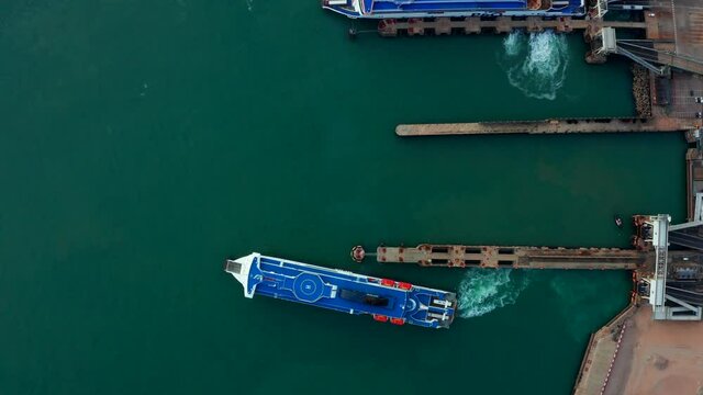 Aerial view of the Dover harbor with many ferries and cruise ships entering and exiting Dover, UK.