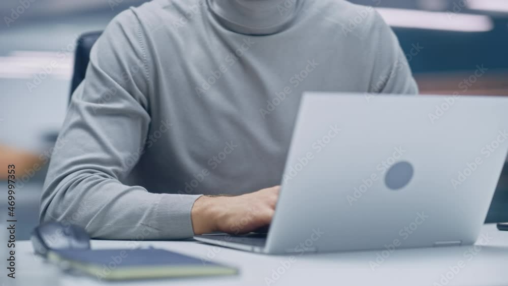 Poster 360 degree modern office: portrait businessman sitting at his desk working on a laptop computer. man