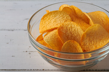 potato chips in a bowl on white table unhealthy snack