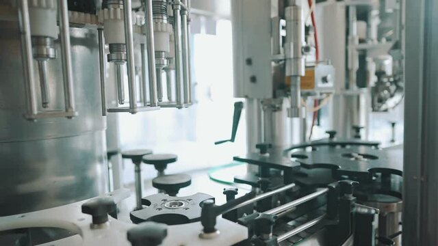 Automatic monoblock wine filling machine at wine factory.