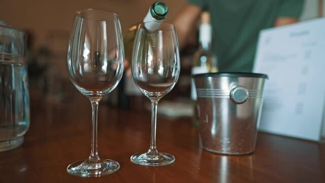 Sommelier pours a glass of wine for a tasting.