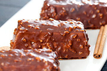cake with peanuts poured with chocolate c