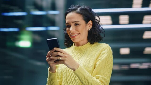 360 Degree Street Shot: Portrait of Beautiful Latin Woman Using Smartphone. Smiling Hispanic Female Entrepreneur Using Mobile Phone for Online Shopping, e-Commerce Happily. Tracking Moving Around Shot