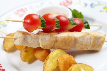 chicken kebab with potato and vegetables