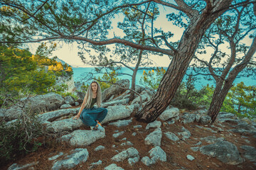 rasta girl with dreadlocks resting on the Mediterranean coast
