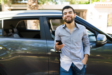 Fototapeta premium Attractive man waiting for friends in his car