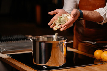 Prepping celery on cutting board ingredients in a large kitchen - Powered by Adobe