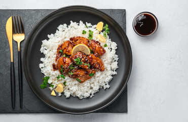 Teriyaki chicken with rice on a gray background. Japanese cuisine.