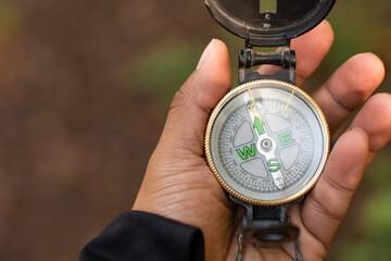 Close up view of a the palm of the hand of a person with a compass - Powered by Adobe