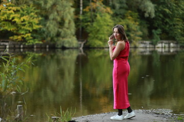 Woman in red dress near the lake