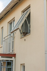 Furry cat sitting in an open window.