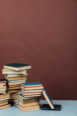 stacks of educational books in the library on a brown background