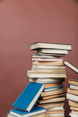 stacks of educational books in the library on a brown background