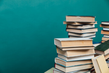 stacks of books in the university library on a green background
