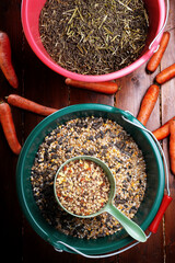 professional  muesli and granules for  horses  served in  buckets with carrots. close up . feeding...