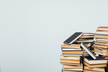 stacks of educational books in the college library on a white background