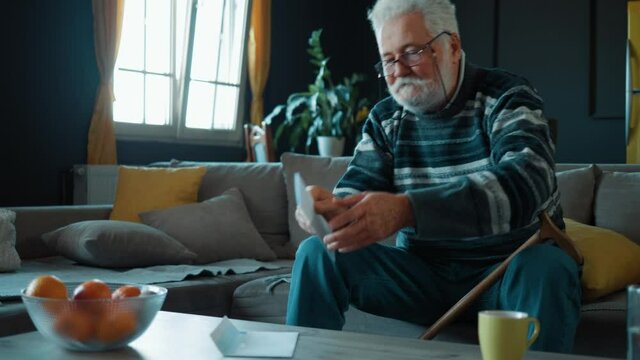 Elderly Person looks forward to reading documents with positive news. Bank loan disbursement notice, mortgage is successfully paid. Positive reaction to the pension increase notice. Rejoice, happiness