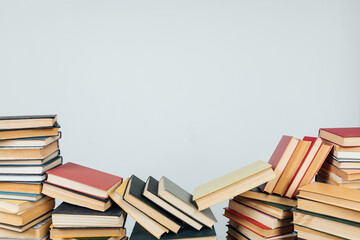 stacks of educational books in the college library on a white background